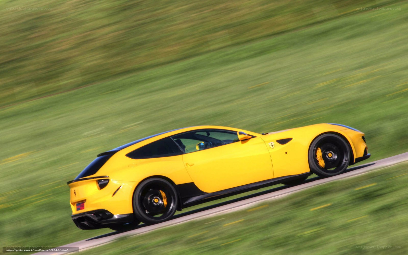 Yellow Ferrari driving on road