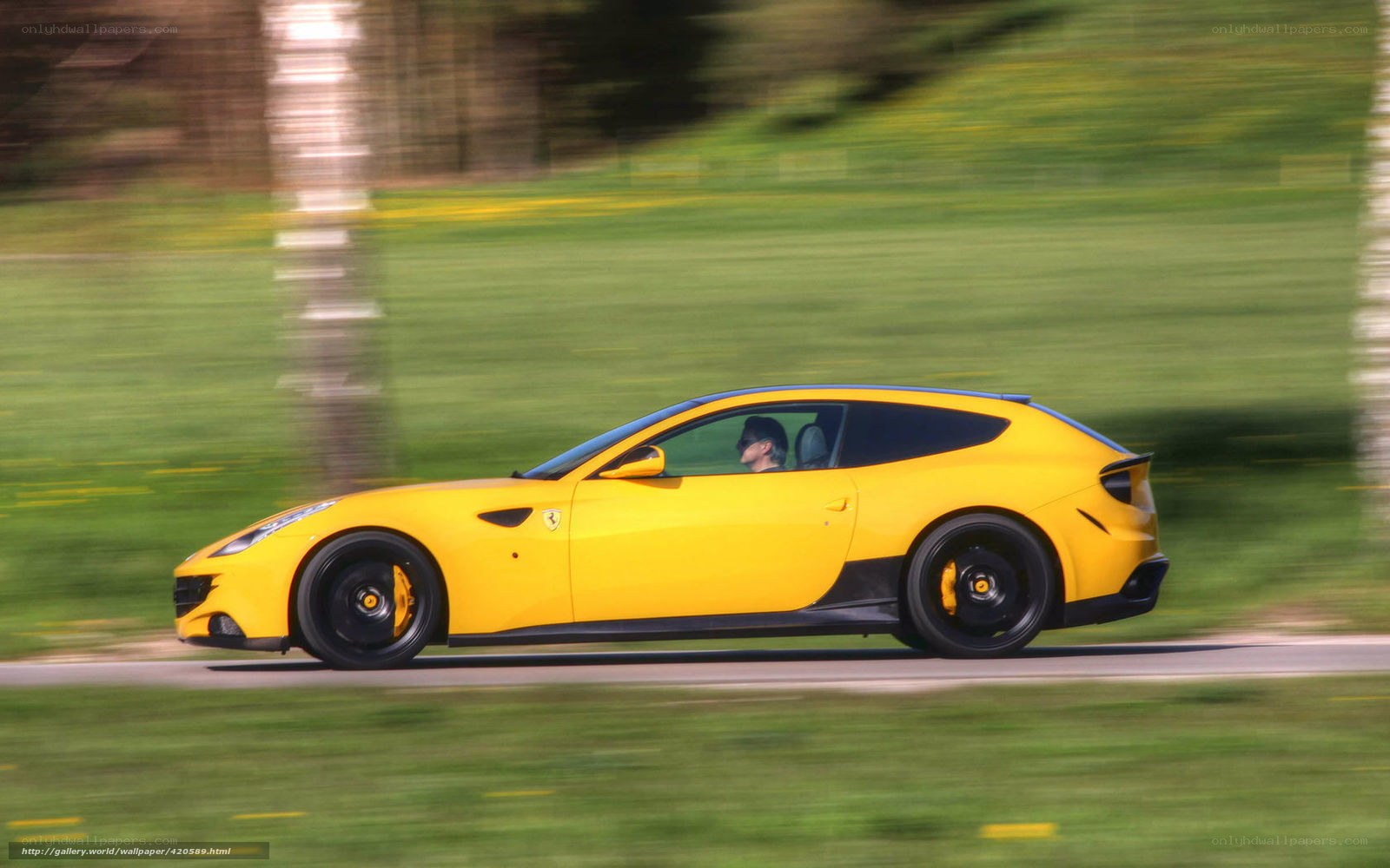 Yellow Ferrari driving on road