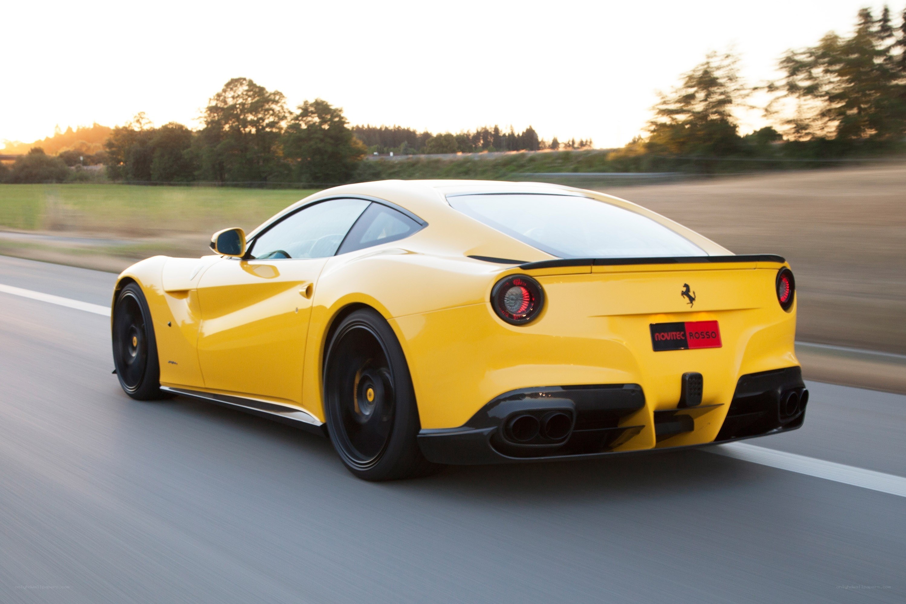 Yellow Ferrari F12berlinetta in motion