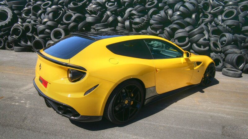 Yellow Ferrari FF parked near tires