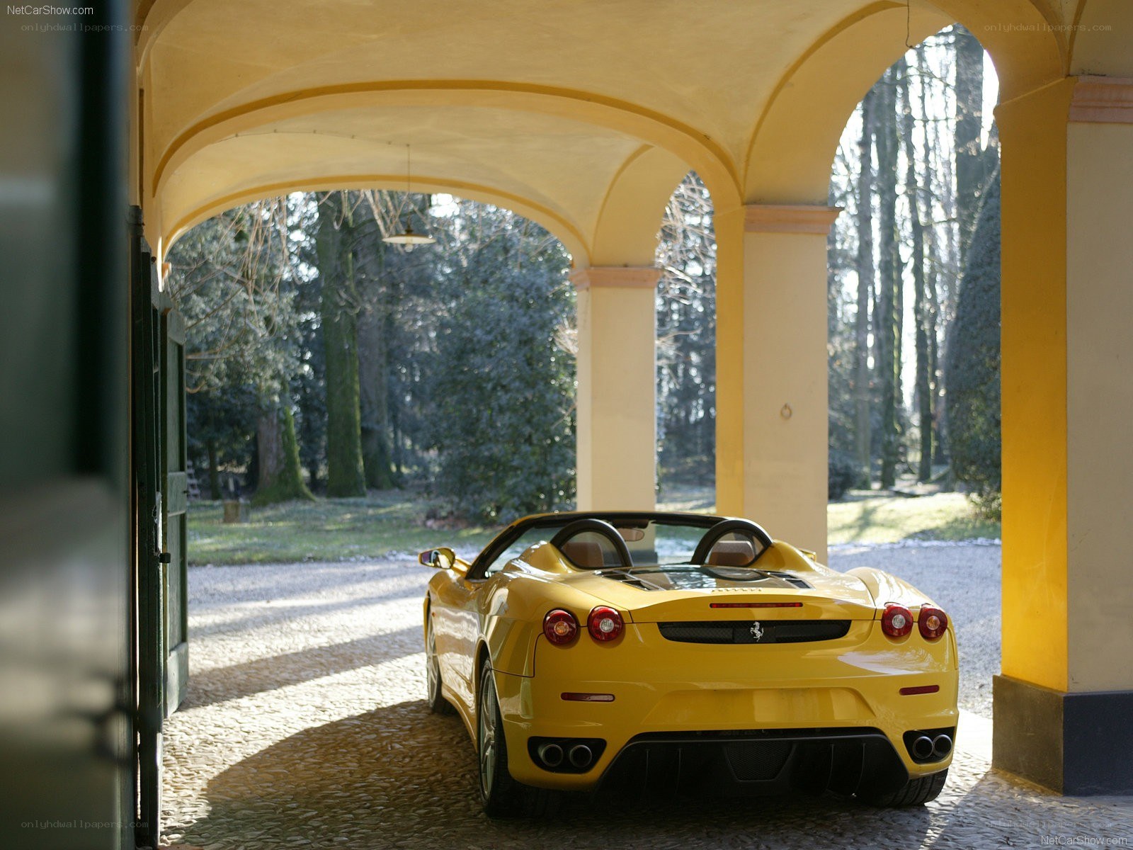 Yellow Ferrari in a covered driveway