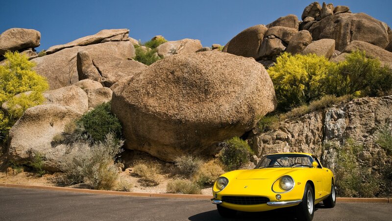 Yellow Ferrari in desert landscape