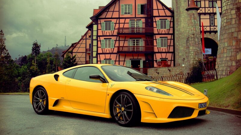 Yellow Ferrari in front of a castle