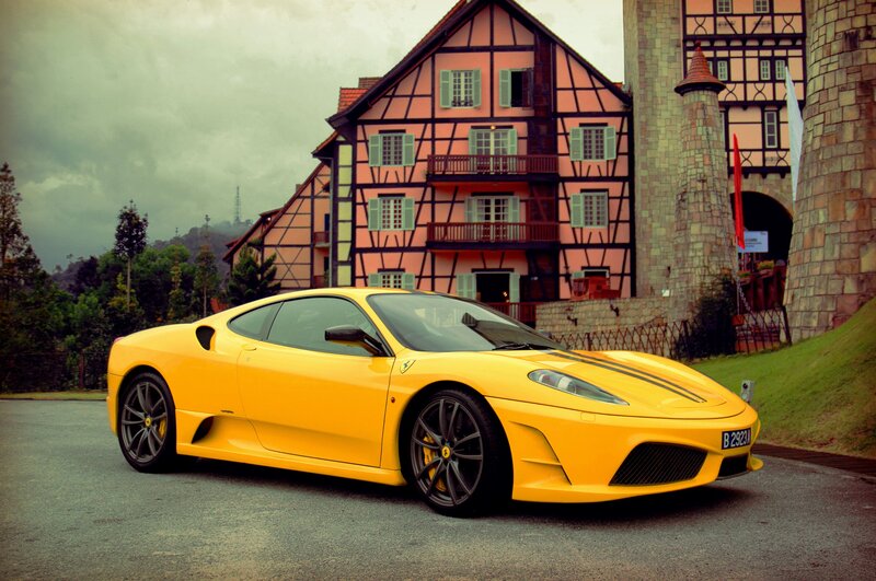 Yellow Ferrari in front of a castle