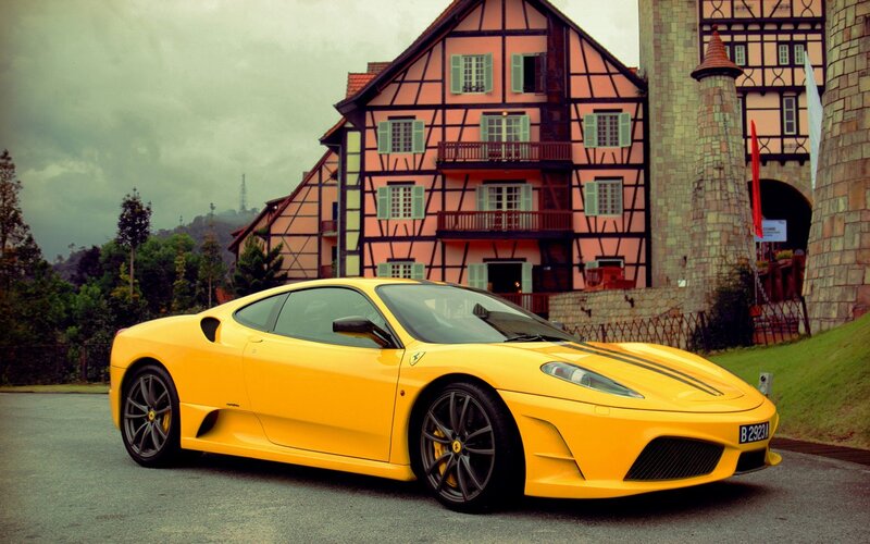 Yellow Ferrari in front of a house