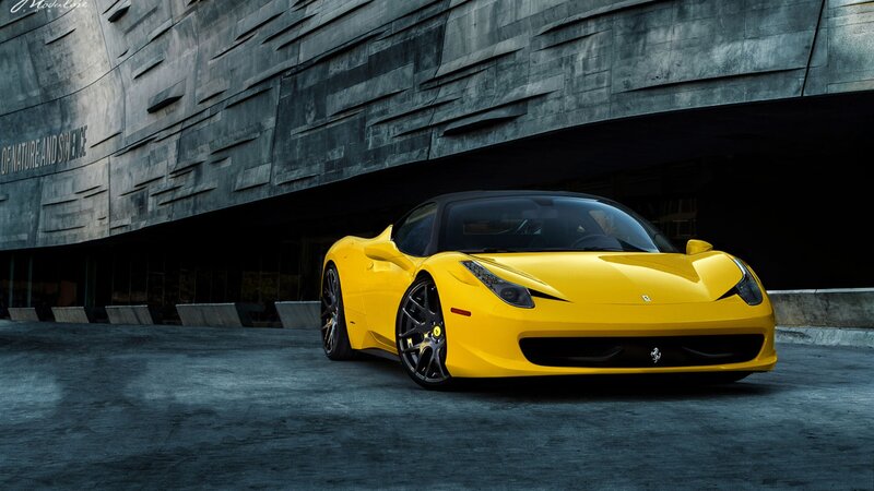 Yellow Ferrari in front of building