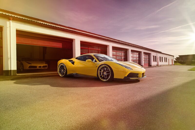 Yellow Ferrari in front of garage