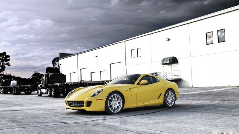 Yellow Ferrari in front of warehouse