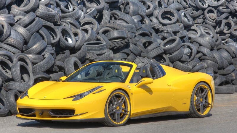 Yellow Ferrari in tire pile