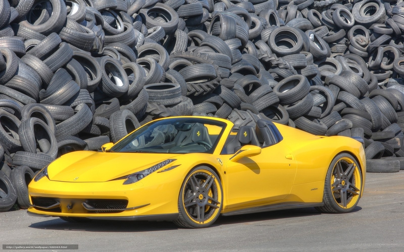 Yellow Ferrari in tire pile