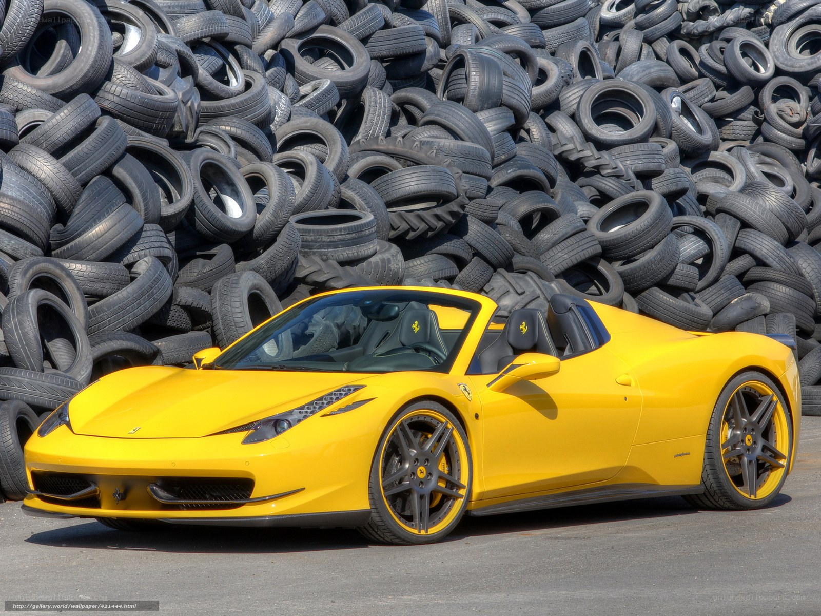Yellow Ferrari in tire pile