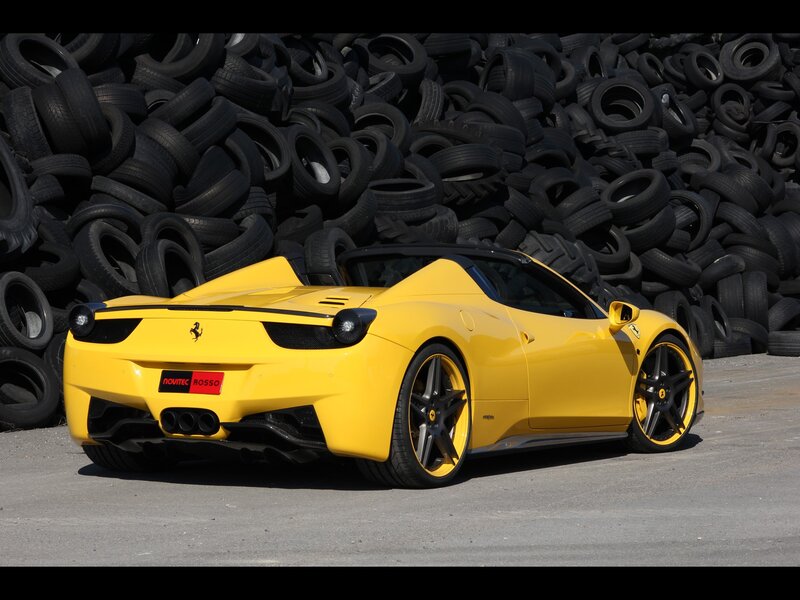 Yellow Ferrari in tire pile