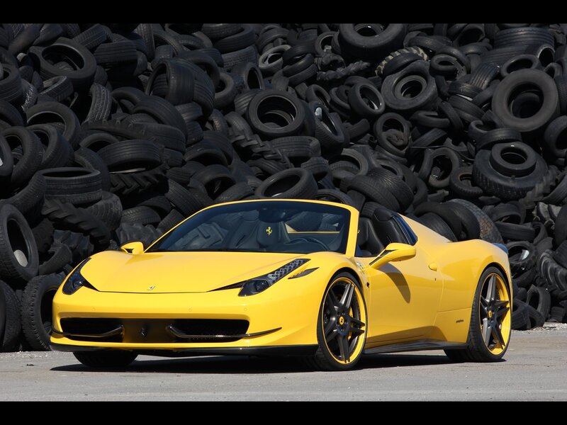 Yellow Ferrari in tire pile