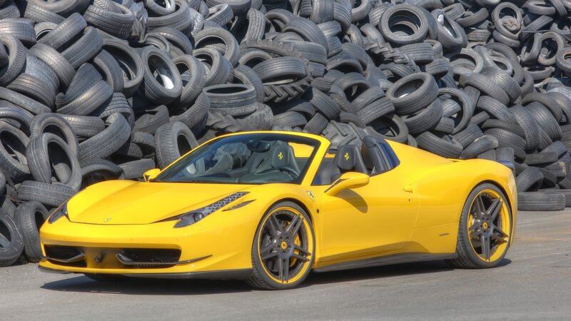 Yellow Ferrari in tire pile