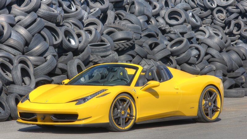 Yellow Ferrari in tire pile