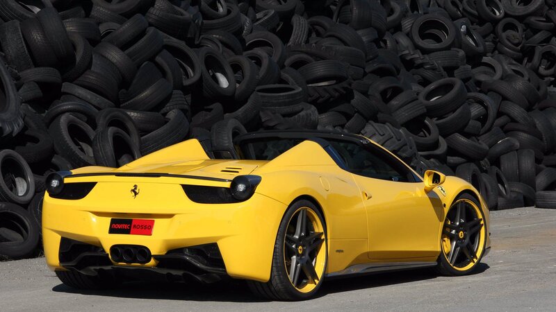 Yellow Ferrari in tire pile