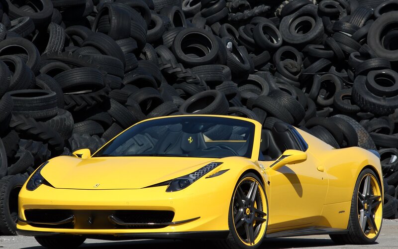 Yellow Ferrari in tire pile