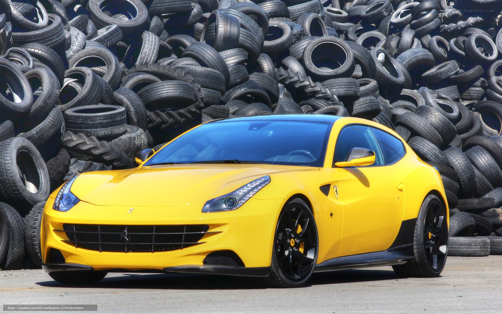 Yellow Ferrari in tire pile