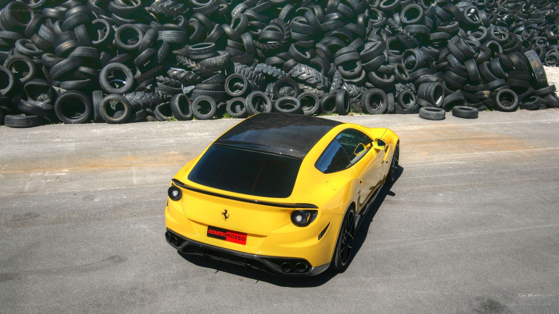 Yellow Ferrari in tire yard