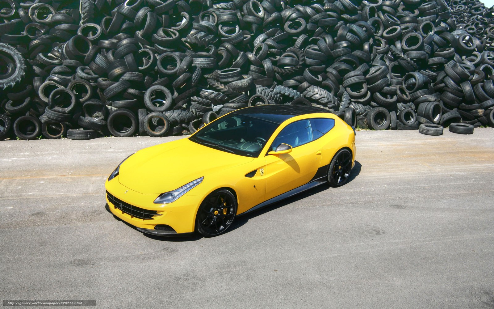 Yellow Ferrari in tire yard