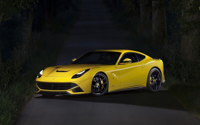 Yellow Ferrari on a dark road