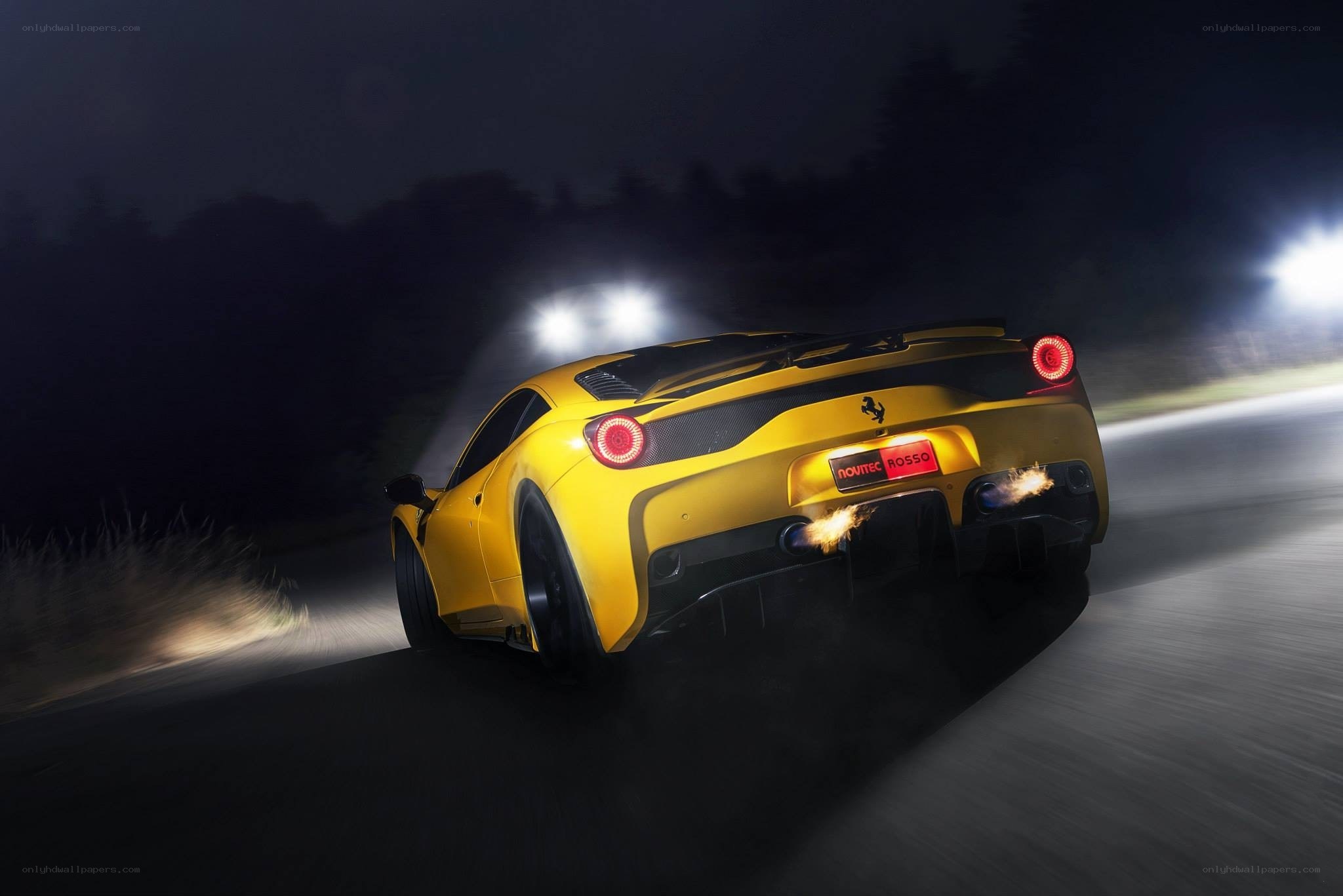 Yellow Ferrari on a night road