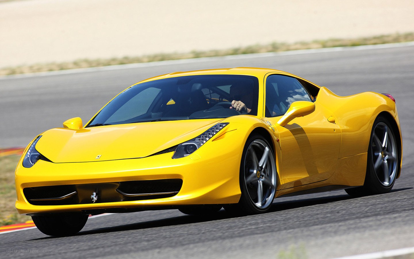 Yellow Ferrari on a racetrack