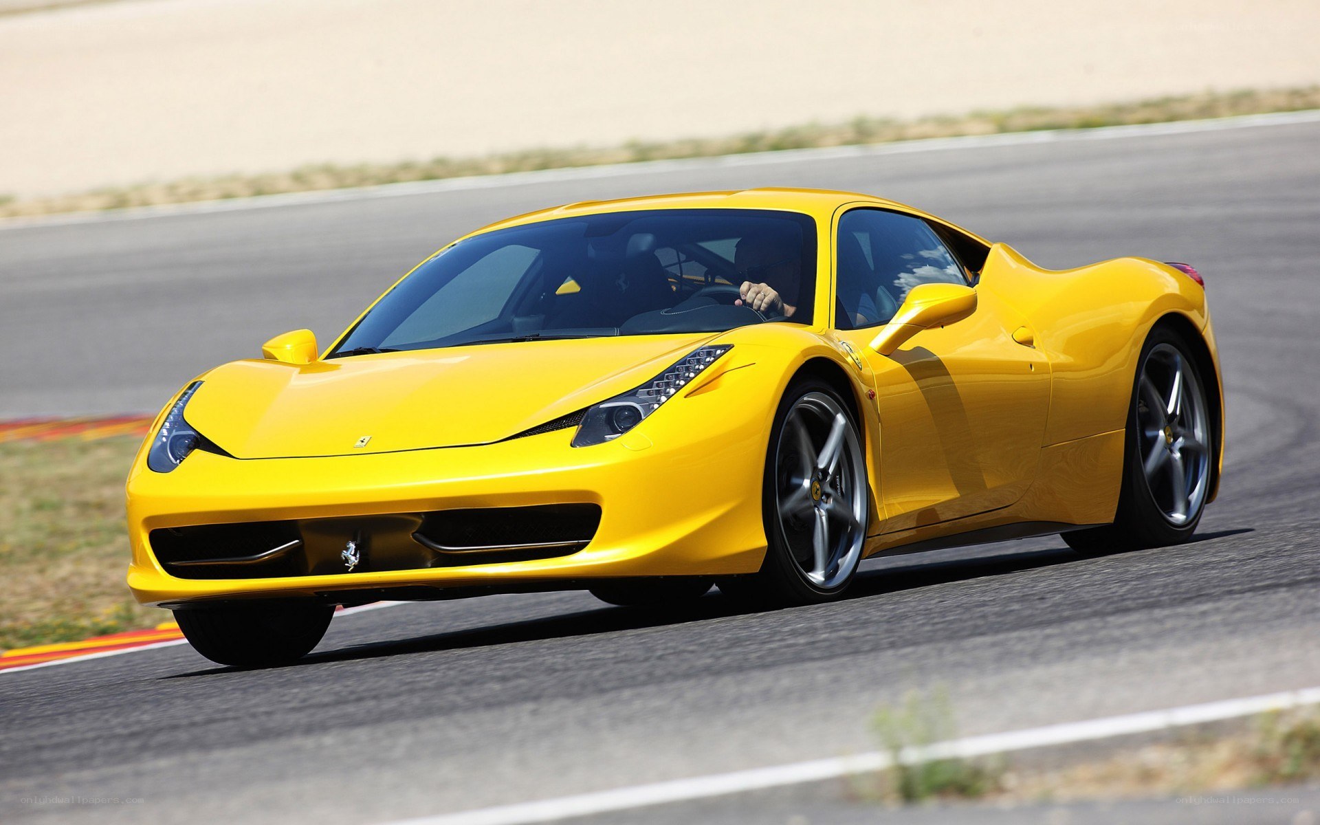 Yellow Ferrari on a racetrack