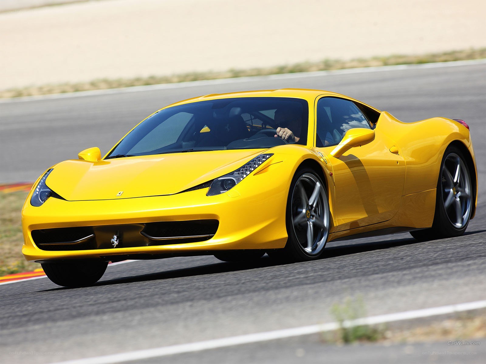 Yellow Ferrari on a racetrack