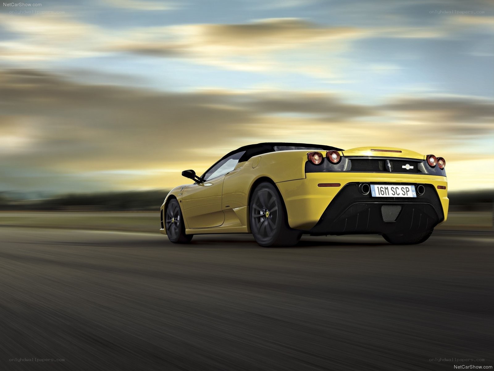 Yellow Ferrari on a road