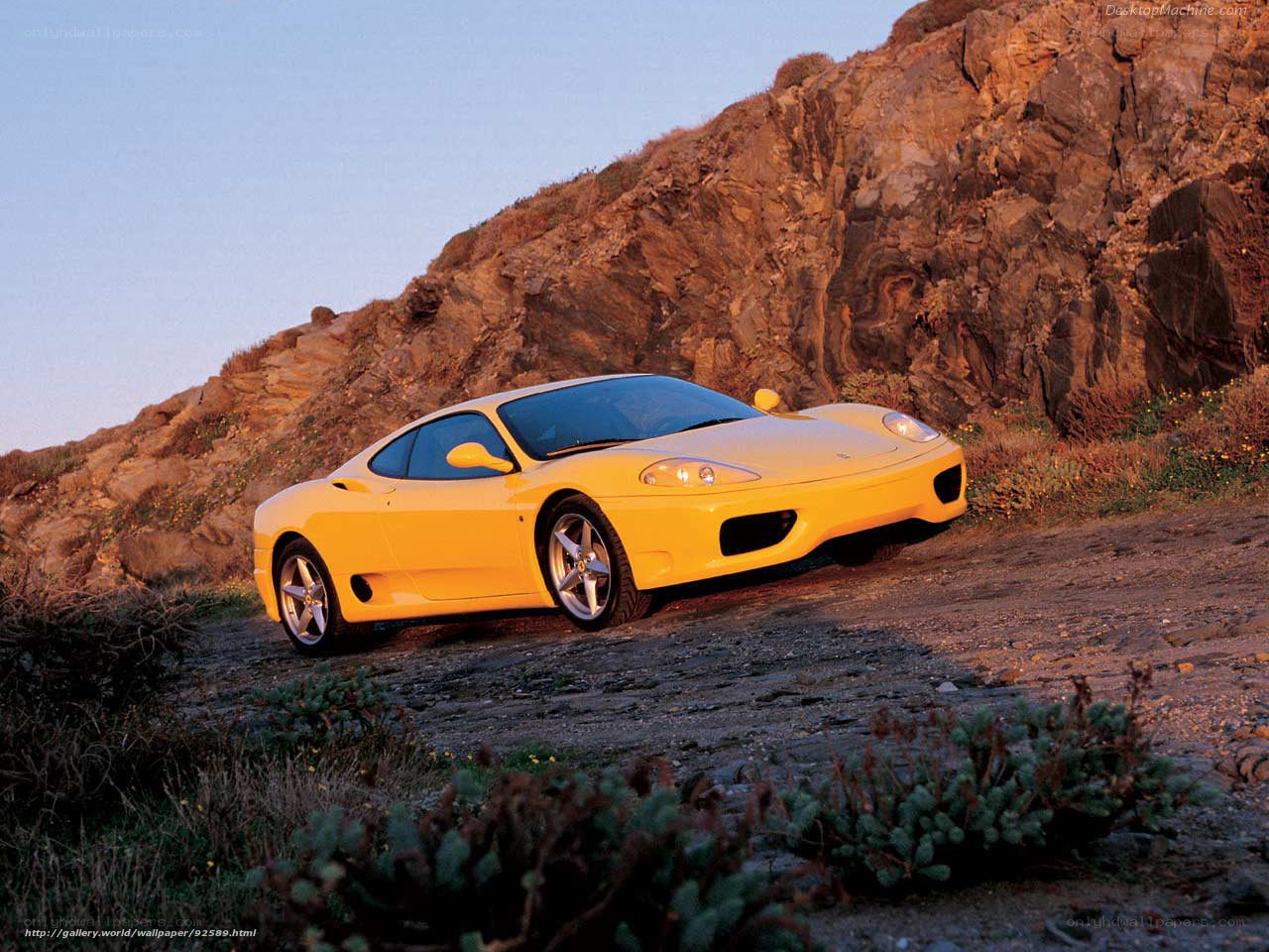 Yellow Ferrari on a rocky path