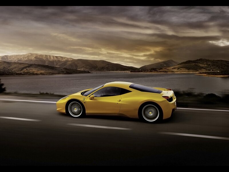 Yellow Ferrari on a scenic road