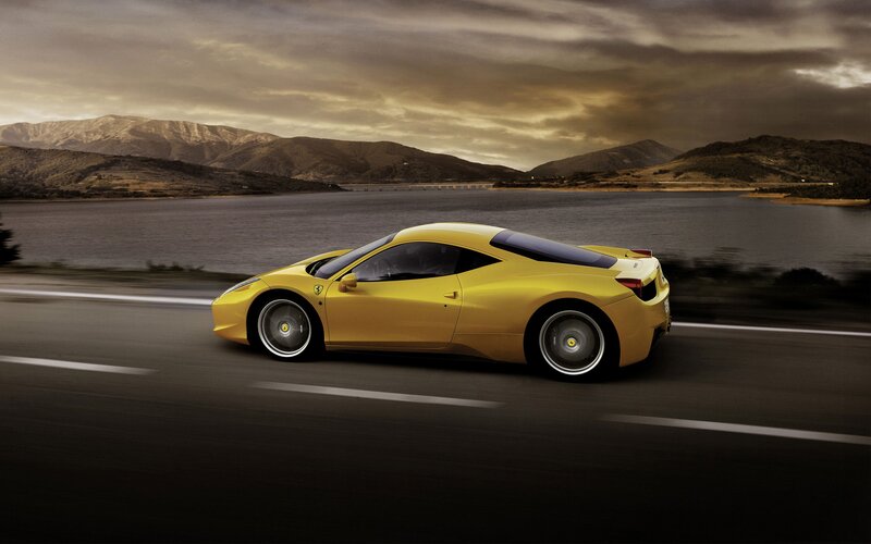 Yellow Ferrari on a scenic road