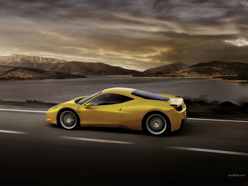 Yellow Ferrari on a scenic road