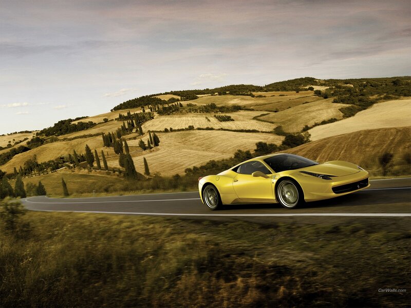 Yellow Ferrari on a winding road