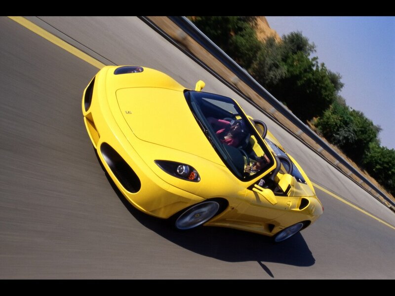 Yellow Ferrari on a winding road