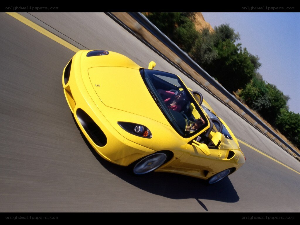 Yellow Ferrari on a winding road