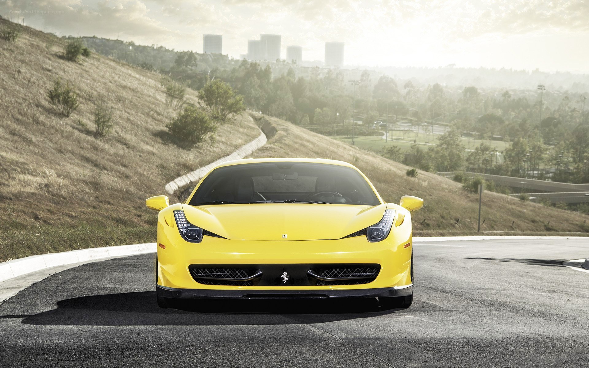 Yellow Ferrari on a winding road