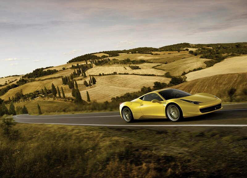 Yellow Ferrari on a winding road