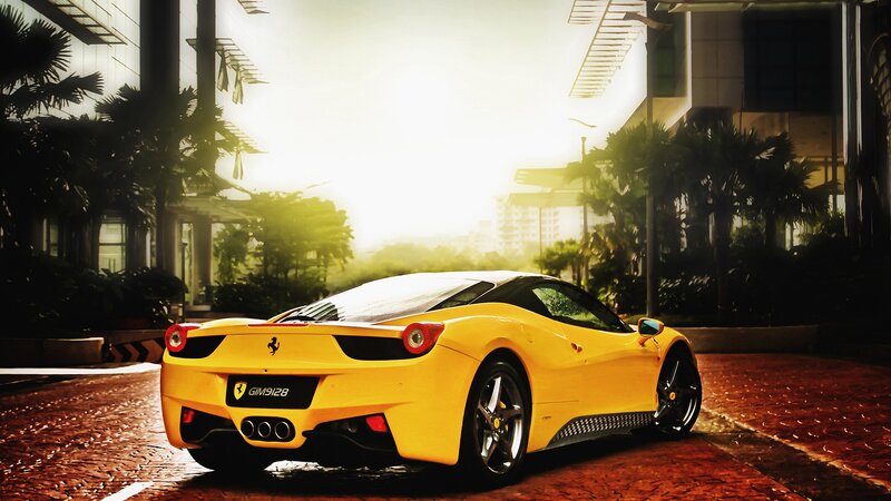 yellow ferrari on city street