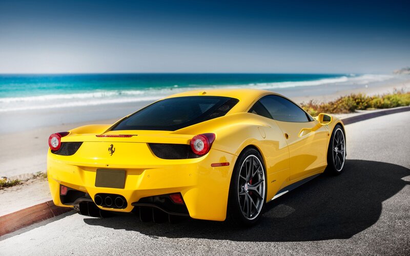 Yellow Ferrari on coastal road