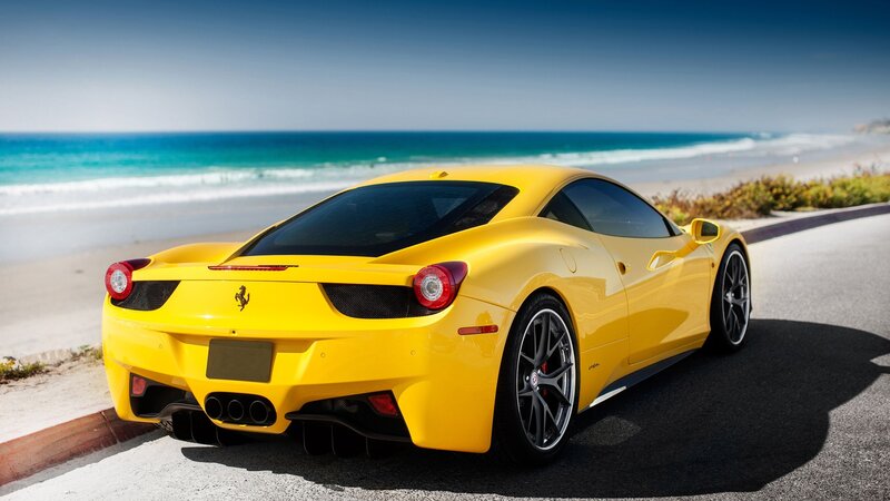 Yellow Ferrari on coastal road
