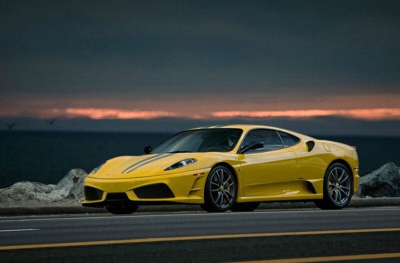 Yellow Ferrari on coastal road