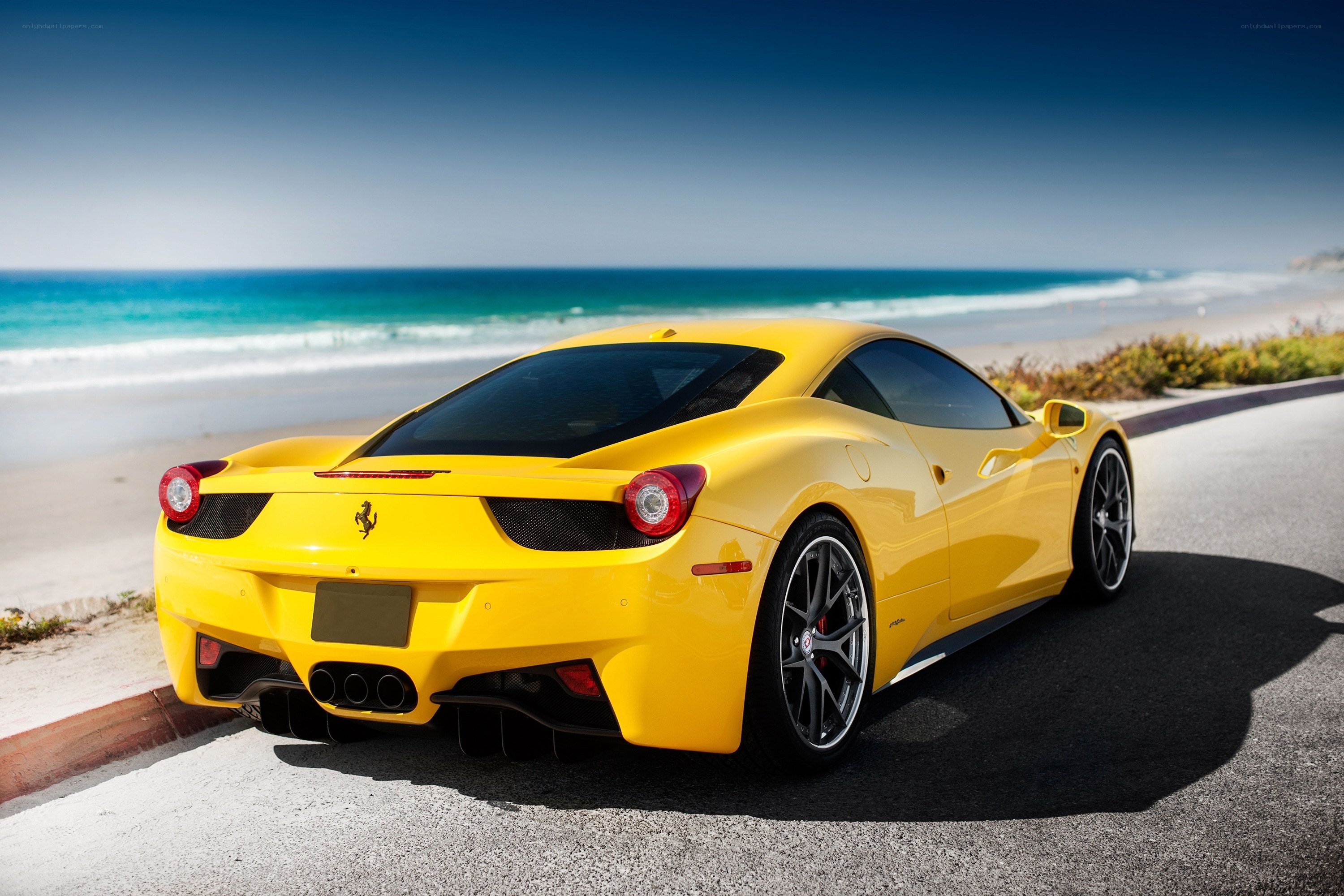 Yellow Ferrari on coastal road