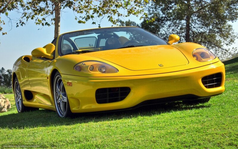 Yellow Ferrari on grass