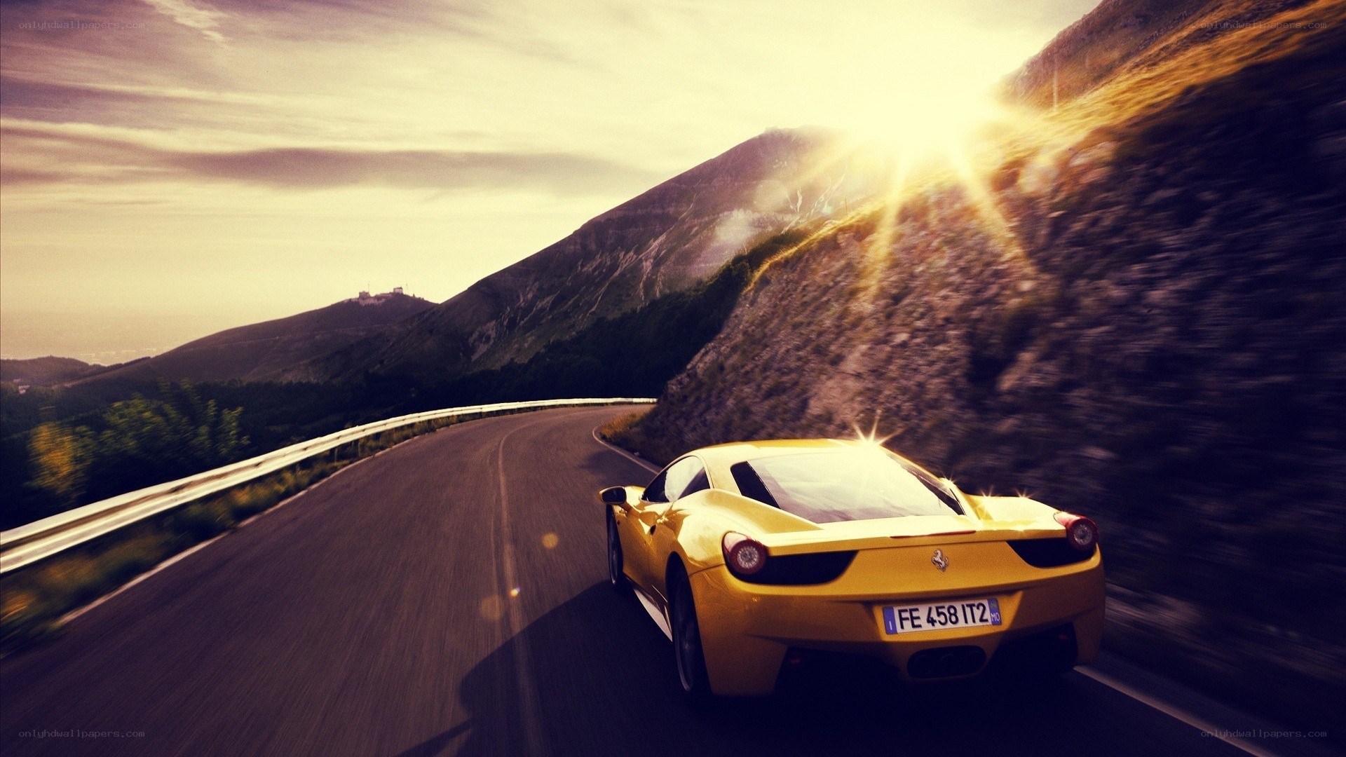 Yellow Ferrari on mountain road