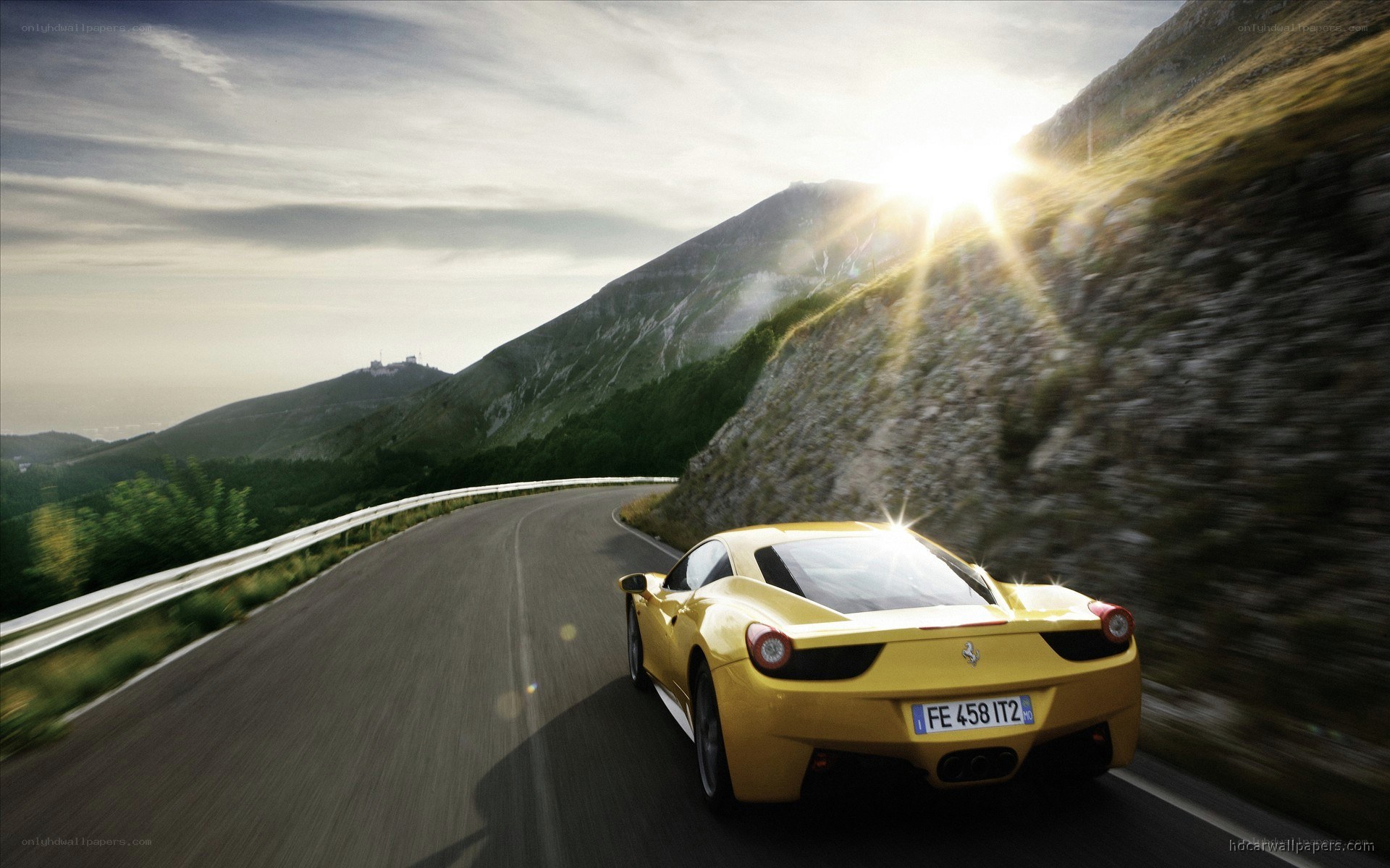 Yellow Ferrari on mountain road