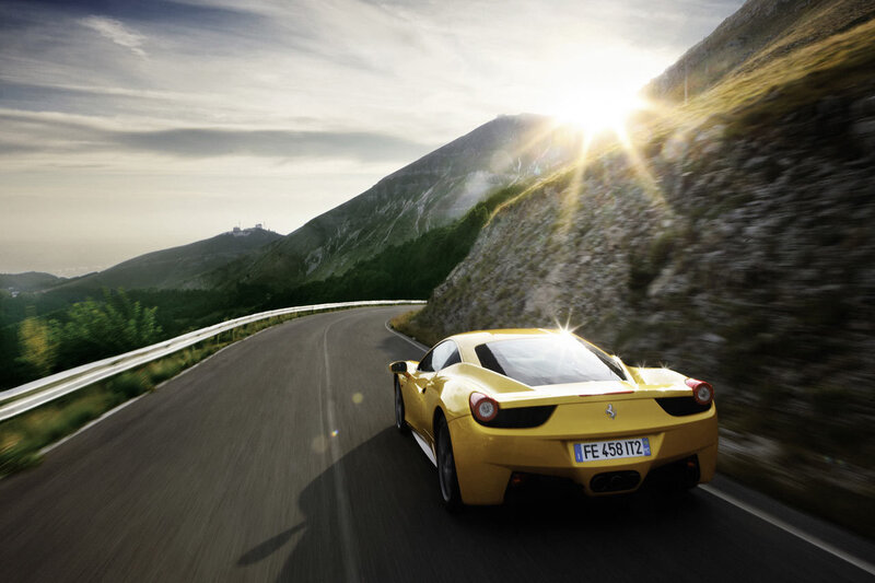 Yellow Ferrari on mountain road