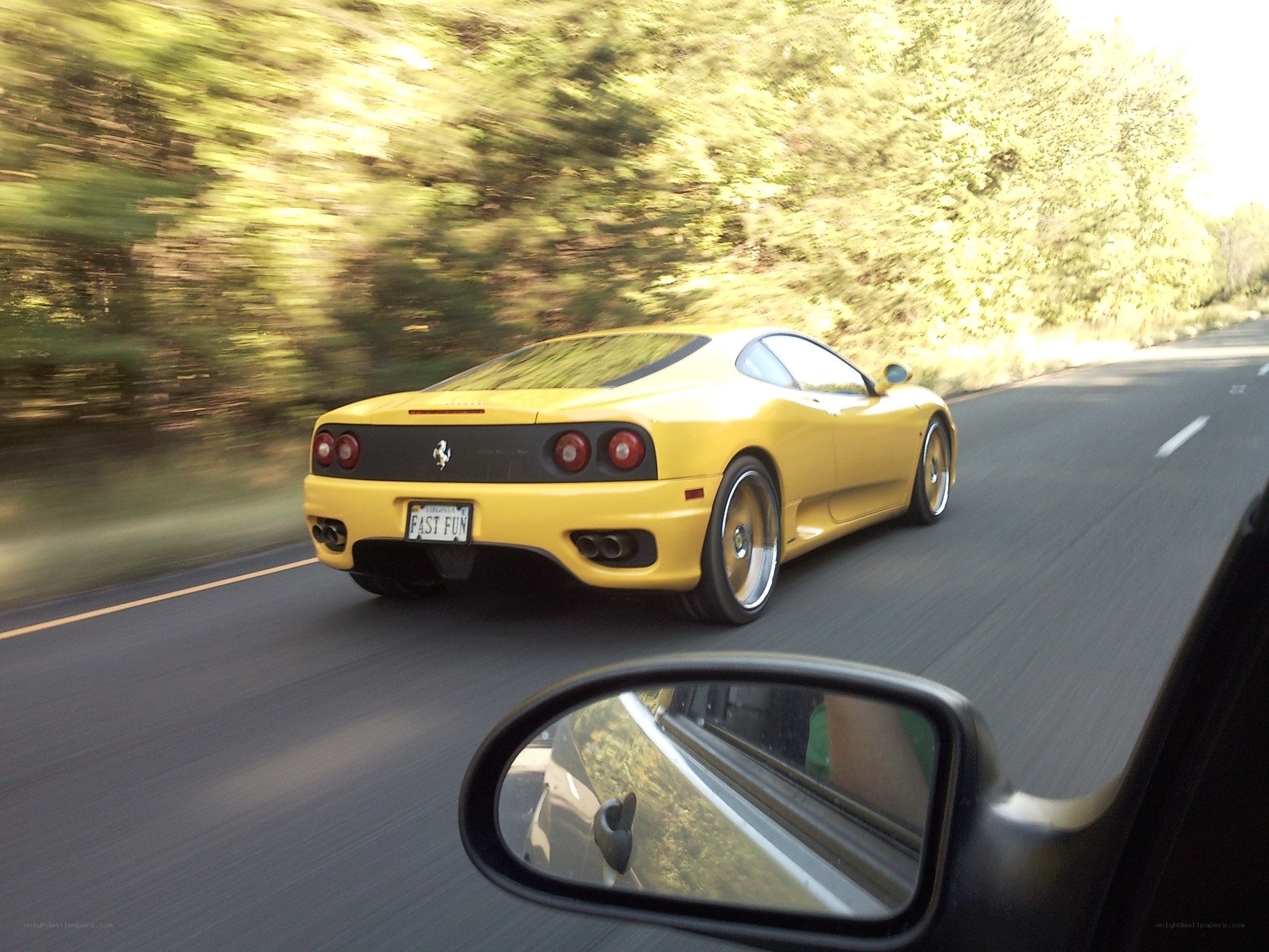 yellow ferrari on road