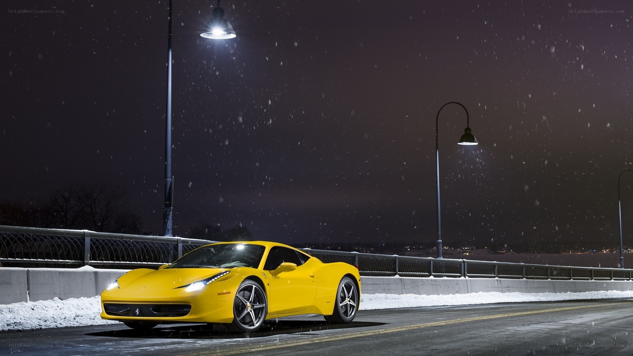 Yellow Ferrari on snowy bridge